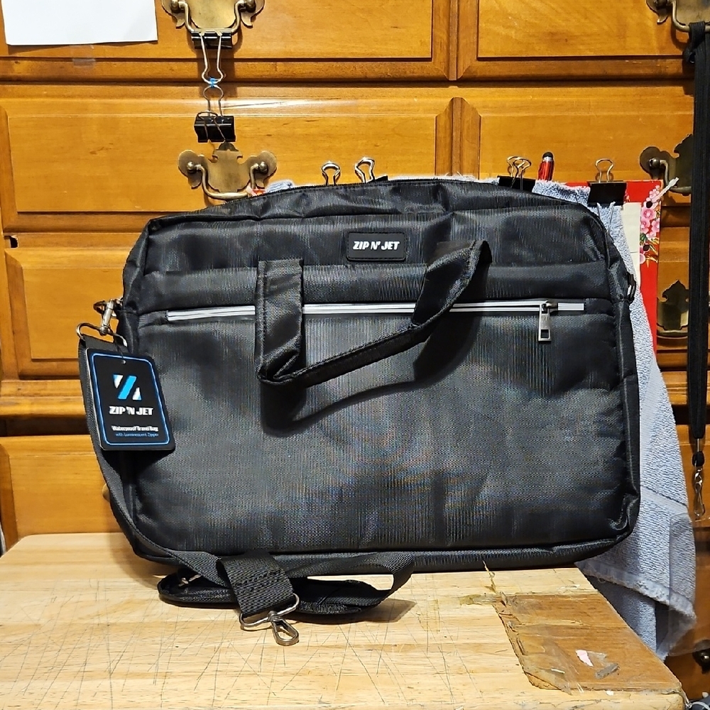 Zip 'N Jet waterproof travel bag. Black color w/strap.